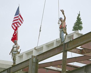 The Vindicator/Robert K. Yosay ---Kevin Conway and Ted Nickoloff Local 207 Ironworkers Salute as  THE BEAM is layed ontop of the building   as  University officials and others will sign the final steel beam going into the $34,3 million building.  The beam, carrying U.S. and YSU flags, will then be hoisted into place.  110,000-square-foot facility to  ready for occupancy in fall 2010.  YSU is raising $16 million in private donations to help pay for the construction. 

0232009