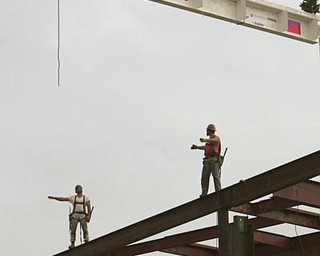 The Vindicator/Robert K. Yosay ---Kevin Conway and Ted Nickoloff Local 207 Ironworkers guide  THE BEAM  as  University officials and others will sign the final steel beam going into the $34,3 million building.  The beam, carrying U.S. and YSU flags, will then be hoisted into place.  110,000-square-foot facility to  ready for occupancy in fall 2010.  YSU is raising $16 million in private donations to help pay for the construction. 

0232009