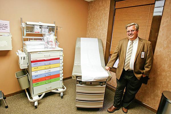 A LOOK INSIDE: Michael Seelman, chief operating officer of Forum Health Services, shows off one of the five examination rooms in the Hubbard immediate-care center on North Main Street, which opened to the public Wednesday. 
