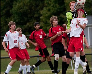 The Vindicator/Geoffrey HauschildMathews' Mike Ponikvar gets his head on the ball knocking it free from the hands of Columbiana goalkeeper Alex Bable during the first half of a game at Mathews on Thursday evening. Although another Mathews player was able to score shortly after the ball was knocked free the game ended in a tie 1-1.9.24.2009