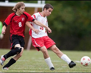 The Vindicator/Geoffrey HauschildMathews Tim Nowery (16) makes a pass as Columbiana's Tommy Saunders (8) struggles to defend the ball during a game at Mathews on Thursday evening. The game ended in a tie 1-1.9.24.2009