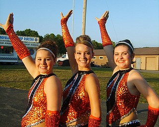 Springfield Local majorettes, Amanda Lehnard, Becca Platt, and Amanda Dicks, prepare before their game against Lisbon. 