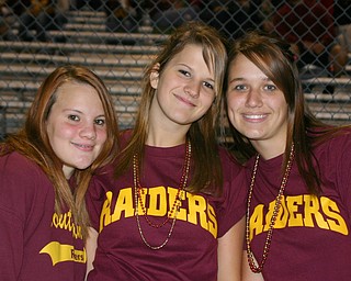 "Danielle Hoffman, Cheyenne Bhor, and Stephani Rutushin wear their
burgundy and gold for South Range."
