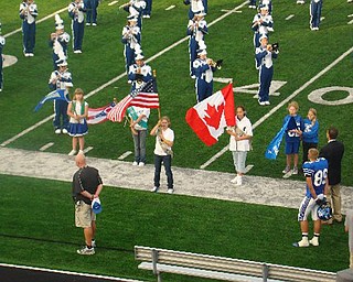 Poland kicked off their home opener and new stadium with St. Thomas More of Ontario Canada.  Here the PSHS Band in their new uniforms, play the Canadian and United States National Anthems.