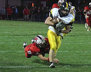 CRESTVIEW - COLUMBIANA - (9) Adam Britton makes the catch as (42) Jeff Davidson makes the tackle during their game Friday night. - Special to The Vindicator/Nick Mays