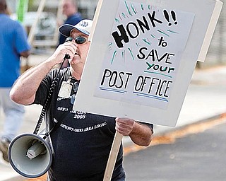 CHANT LEADER: Rick Joseph, a member of the American Postal Workers Union Local 443, leads pickets Friday at the downtown post office as they chant, “Save our service. Keep them open. SOS.”