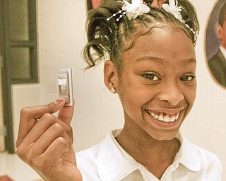 PROUD OWNER: Morgan Jones, a fifth grader at Youngstown Community School, proudly displays the iPod Shuffle she was given for successfully passing all reading, math and writing state proficiency tests last school year.  More than 40 percent of the school’s 187 students in grades three through six last year earned the reward given by school benefactor Edward Muransky.