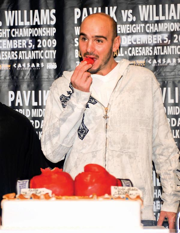 TASTY: Kelly Pavlik tastes a piece of a boxing glove cake at a news conference in East Rutherford, N.J., on Tuesday
