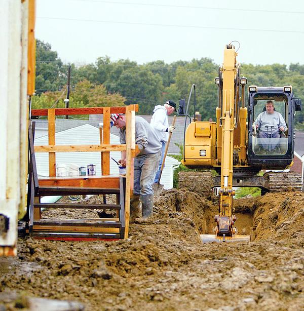 WASTING NO TIME: After the symbolic ground-breaking, the real thing got started immediately on the 2,000-plus-square-foot home.