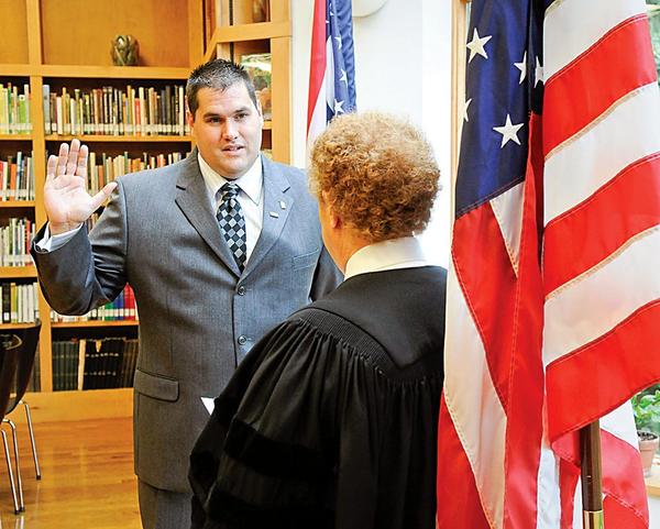 SWEARING-IN: James Willock Jr. is administered his oath as police chief of Mill Creek MetroParks by Mahoning County Probate Court Judge Mark Belinky. Willock officially was named chief during a ceremony Wednesday at the D.D. and Velma Davis Education and Visitor Center in Fellows Riverside Gardens.