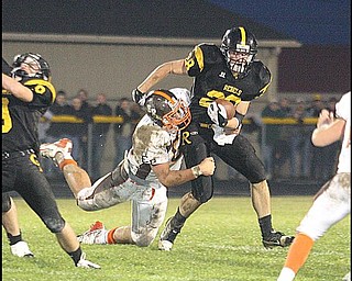 CRESTVIEW - EAST PALESTINE - (28) Andrew Mayer tries to get away from (60) Ben Gysin during their game Friday night. - Special to The Vindicator/Nick Mays