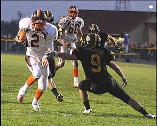 CRESTVIEW - EAST PALESTINE - (2) Shane Peterson gets away from (9) Adam Britton for a score during their game Friday night. - Special to The Vindicator/Nick Mays
