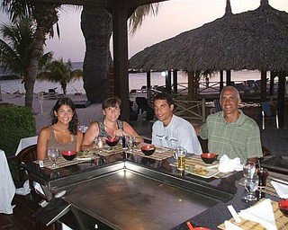 Lisa and Dominic Pannunzio, along with their children Andrea and Anthony, enjoy dinner cooked outdoors on the beach on the island of Curacao, part of the Netherland Antilles.