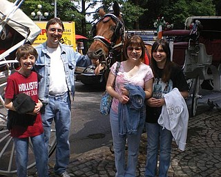 Eric and Melissa Pregi of Boardman and their children, Sean and Liana, have just finished a carriage ride in New York's Central Park.