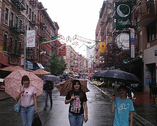 Melissa, Liana and Sean Pregi of Boardman stroll through Little Italy during a family vacation in New York.