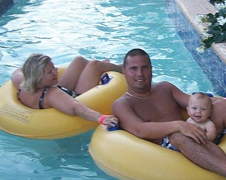 Bryan and Karen Gough are 'making sure the ride is safe' for their son, Eli, in the lazy river at the Carribean Resort in Myrtle Beach in July. The picture was taken by Grandma Nancy Gough of Struthers.