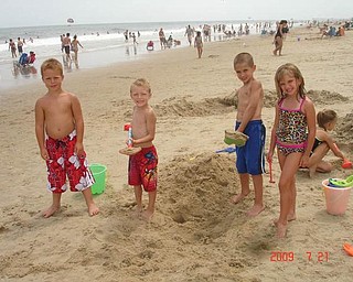 Friends Ronnie Hryb, 8, Zachary Hryb, 6, Michael Cougras, 8, and Connie Cougras, 6, enjoy a day at the beach in July.