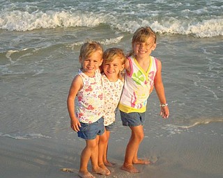 Lindsay and Allison Jones, 4, and Samantha Jones, 5, are enjoying their first time at the beach in July in Alabama.