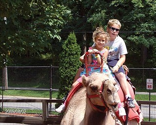 Matthew and Julia Ranno, children of Sam and Donna Rano of Poland, enjoy a camel ride at the Cleveland Zoo.