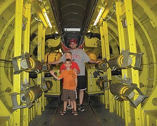 Joe, Alex and Anthony Weimer of Poland are inside an aircraft carrier at Wright Patterson Air Force Base in Cincinnati.