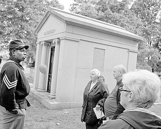 HISTORIC EVENT: GThe Mahoning and Shenango Valley Historical Club gave a presentation Saturday at the South Side cemetery. Steffon Wydell Jones is dressed as a Civil War soldier as he talks about the life of Thomas W. Sanderson, a former Youngstown mayor who is buried in this mausoleum. Listening are Virginia and Ed Mannion of Columbiana and Alma Gabriel of Warren.