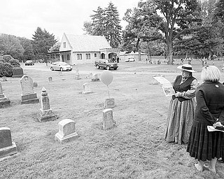 Judy Foster of Enon Valley, Pa., above right, wears a period costume as she talks to Sandy and Patrick Gatta of Poland about the life of Frederick Workman, a Gettysburg veteran who died in 1888. The Gattas said they are considering joining the historical club.