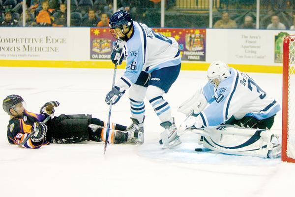 The Vindicator/Geoffrey HauschildIndiana Ice's Goal Kepper, Casey DeSmith, places his glove over the puck as teamate Alexander Kuqali, defends against Mahoning  Valley Phantom's Brett Gensler who comes to a sliding stop after being knocked off balance during his shooting attempt during the first period at the Covelli Centre on Saturday evening.10.3.2009