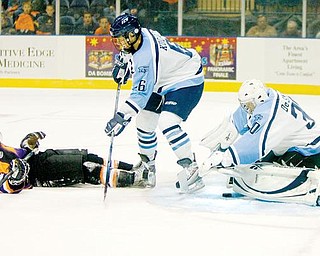 The Vindicator/Geoffrey HauschildIndiana Ice's Goal Kepper, Casey DeSmith, places his glove over the puck as teamate Alexander Kuqali, defends against Mahoning  Valley Phantom's Brett Gensler who comes to a sliding stop after being knocked off balance during his shooting attempt during the first period at the Covelli Centre on Saturday evening.10.3.2009