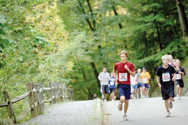 The Vindicator/Geoffrey HauschildAlan Burns, age 13 of Boardman, and  Zach Stamp, age 12 of Boardman, run through Mill Creek Metro Park during the Peace Race on Sunday morning.