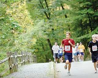 The Vindicator/Geoffrey HauschildAlan Burns, age 13 of Boardman, and  Zach Stamp, age 12 of Boardman, run through Mill Creek Metro Park during the Peace Race on Sunday morning.