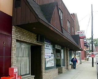 ON THE BLOCK: Nick Noviello heads toward his storefront, where signs advertise this week’s auction.