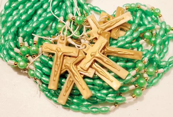 SHARING PRAYER:  Rosaries are packed alongside school, medical and dental supplies to be shipped to El Salvador. 