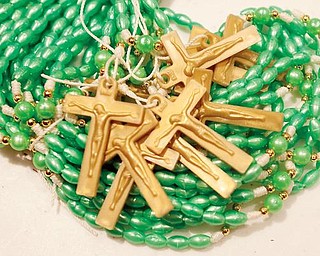 SHARING PRAYER:  Rosaries are packed alongside school, medical and dental supplies to be shipped to El Salvador. 