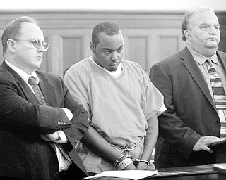 ACCUSED OF DOUBLE MURDER: Lorenza I. Barnette, center, charged with two counts of aggravated murder, two counts of kidnapping, two counts of aggravated robbery, and arson, enters a plea of innocent Tuesday to those charges in Mahoning County Common Pleas Court. He is flanked by his attorneys Paul C. Conn, left, and Thomas E. Zena.