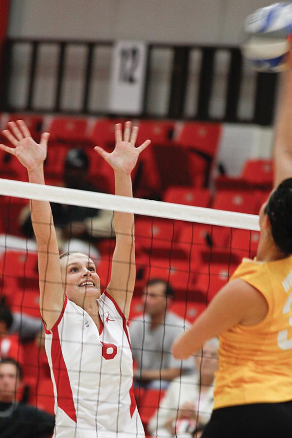 YSU's Brittany Grove (8) blocks the oncoming ball from Wright State Becca Awaa (33)