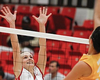 YSU's Brittany Grove (8) blocks the oncoming ball from Wright State Becca Awaa (33)