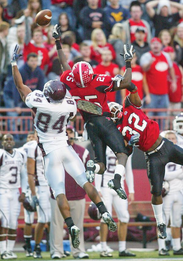 Missouri's Clay Harbor tries to bring in a second quarter pass during Saturday Oct 3, 2009 game at Youngstown State, Defending for Youngstown are Sir Demarco Bledsoe, center, and Lenny Wicks. The pass was incomplete.
