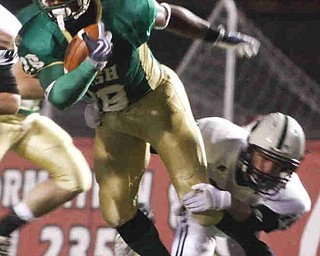 The Vindicator/Lisa-Ann Ishihara--- Irish's Allen Jones (28) with Central Catholic's defensive back Zach Ungashick (34) grasping his leg during the first quarter at Stambaugh Stadium Friday October 9, 2009