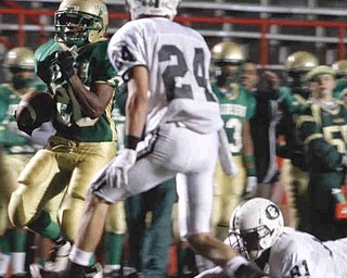 The Vindicator/Lisa-Ann Ishihara--- Irishman Allen Jones (28) flies past Dillon Stertzbach (24) and Carmen Bonamico (81) to score a touchdown during the first quarter at Stambaugh Stadium Friday October 9, 2009
