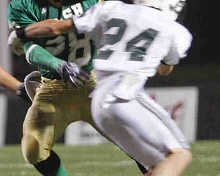 The Vindicator/Lisa-Ann Ishihara--- Irishman Allen Jones (28) escapes the grasp of Central Catholic's Dillon Stertzbach (24) at Stambaugh Stadium Friday October 9, 2009