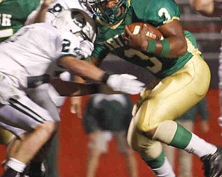 The Vindicator/Lisa-Ann Ishihara--- Ursuline Dawalyn Harper (3) alludes Central Catholic's Dillon Stertzbach (24) to score a touchdown during the first quarter at Stambaugh Stadium Friday October 9, 2009