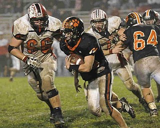 Springfield's (49) JIm Zubick runs the ball  against Columbiana's (66) Matt Douglas during their game on Friday night. Photo/Mark Stahl