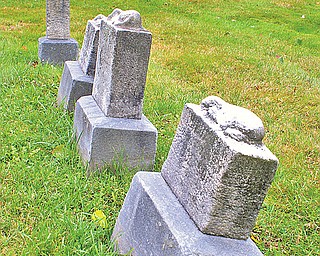 Four tiny stone markers of those taken away too soon
