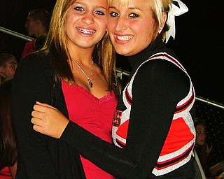 Sisters and best friends, Paige Baker and varsity football cheerleader, Morgan Baker, get together during halftime of the Dover game to hangout.
