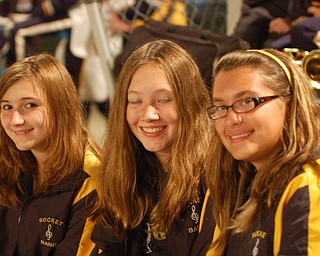 Krista Romano, Kayla Theiser and Antonina Boggia relax after the halftime performance of the Lowellville marching band at the Lowellville/Jackson Milton game.