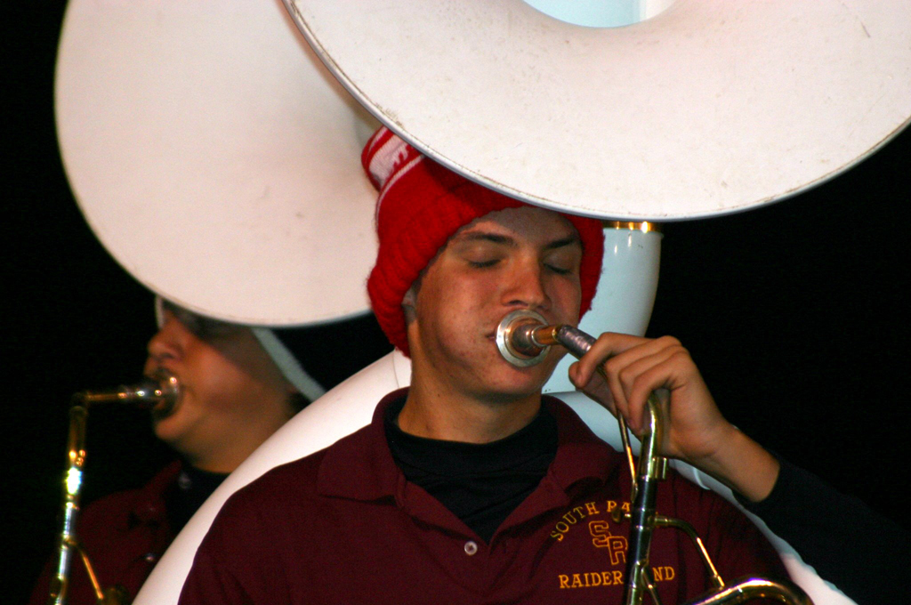 "South Range senior band member Ethan Parks plays the fight song at
the end of the game."
