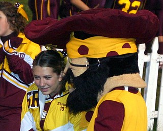"The South Range Raider mascot tells senior cheerleader Brittany
Haynes a secret on the sideline during the game Friday evening."
