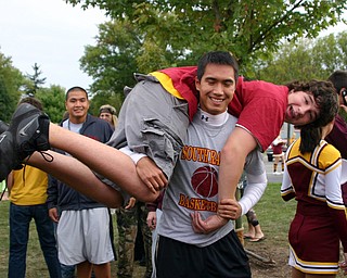 "Peter Dinh hoists a friend at the Blitz tailgate party."
