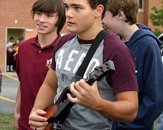 "Brrandon Homan rocks out with Guitar Hero at the Blitz tailgate party."