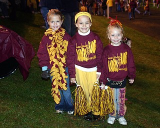 "Reagan Irons, Salli Dispenza, and Emili Boomhower cheered with the
South Range Elementary cheer camp at Friday evening's football game."